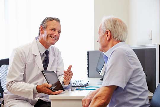 Man with hearing loss talking to a hearing professional